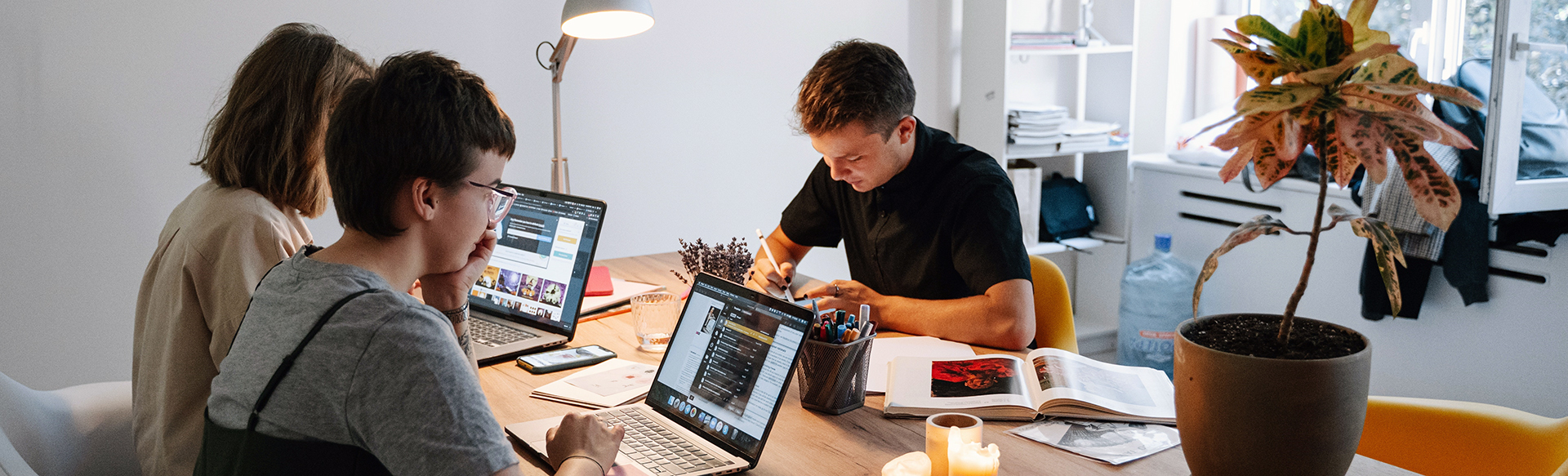 Image depicting friends using laptops in a social setting